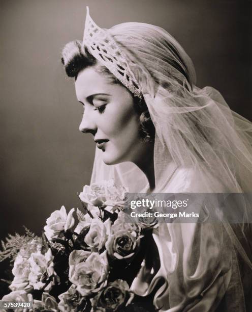 young woman in wedding dress and bouquet in studio, (b&w), close-up - veil stock pictures, royalty-free photos & images