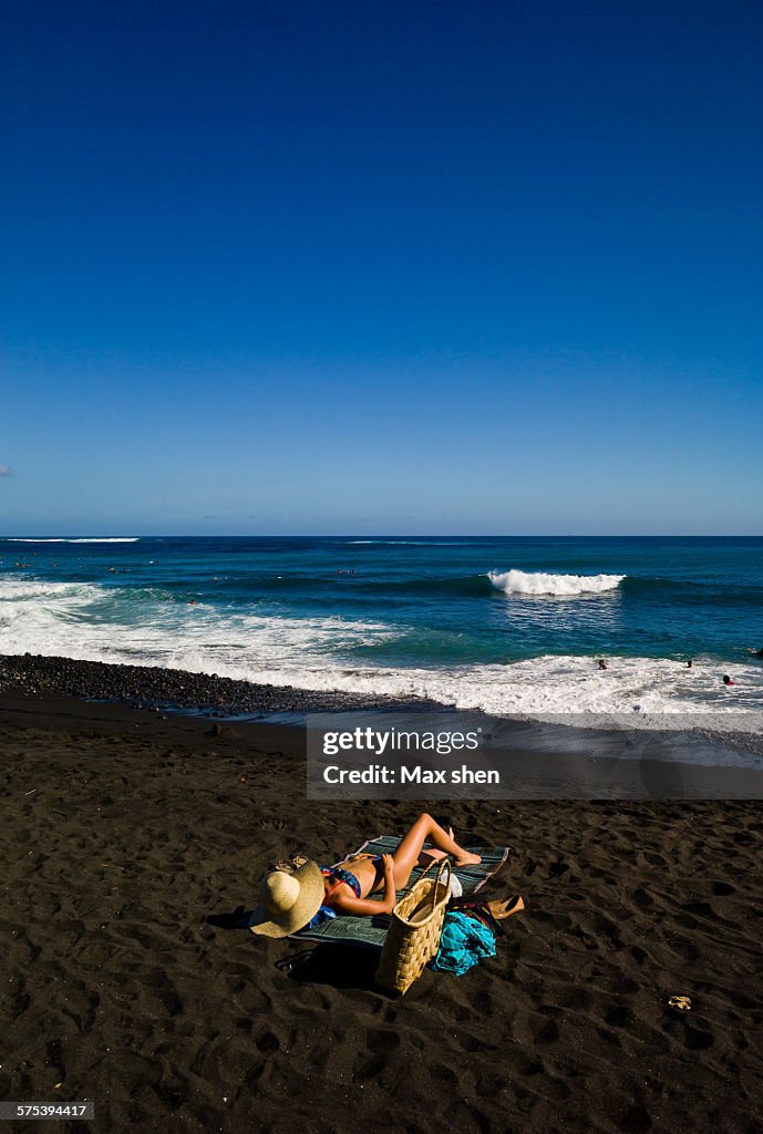 Sunbath on the black sand beach