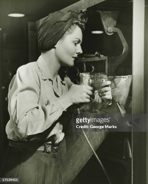 woman working with electric drill in factory, (b&w) - world war ii stock pictures, royalty-free photos & images