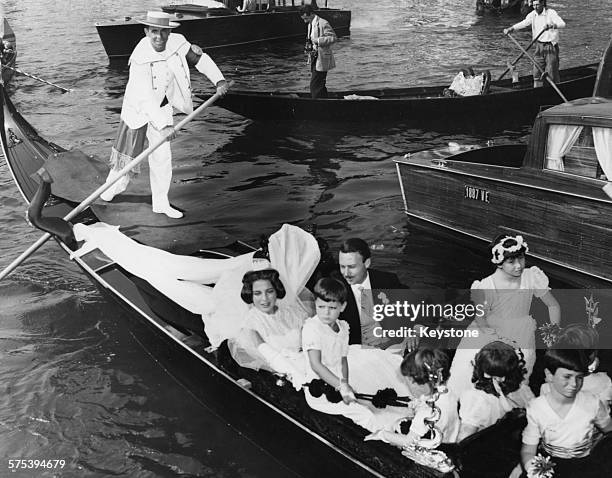 Princess Ira von Furstenberg and Prince Alfonso Hohenlohe Langenburg riding in a gondola with their bridesmaids after their wedding, Venice,...