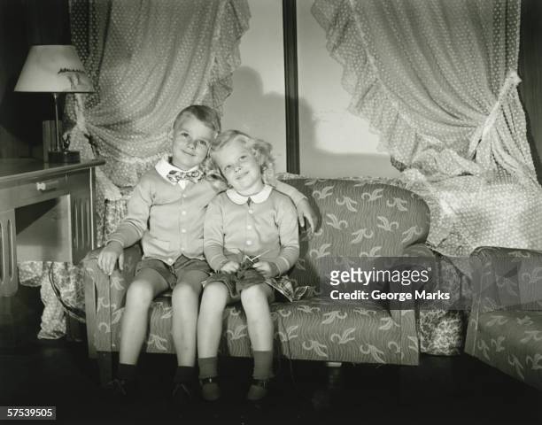 brother and sister (4-5) posing in room, (b&w), portrait - 1940s bedroom stock pictures, royalty-free photos & images