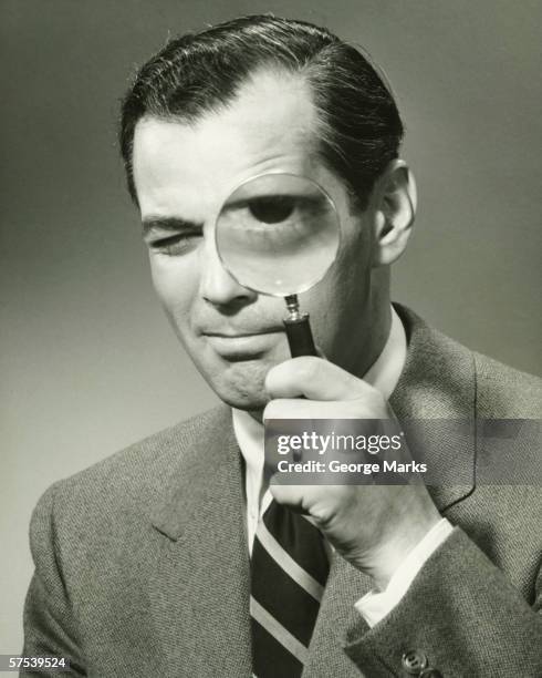 businessman in full suit in studio looking through magnifying glass, (b&w), portrait - funny pics of people stock pictures, royalty-free photos & images