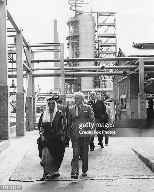 Sheikh Jaber Al Ahmad Al Sabah of Kuwait, walking with a group of officials during an inspection of the Isle of Grain Oil Refinery, England, July 7th...