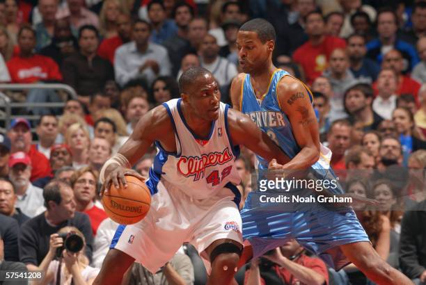Elton Brand of the Los Angeles Clippers moves the ball against Marcus Camby of the Denver Nuggets in game five of the Western Conference...