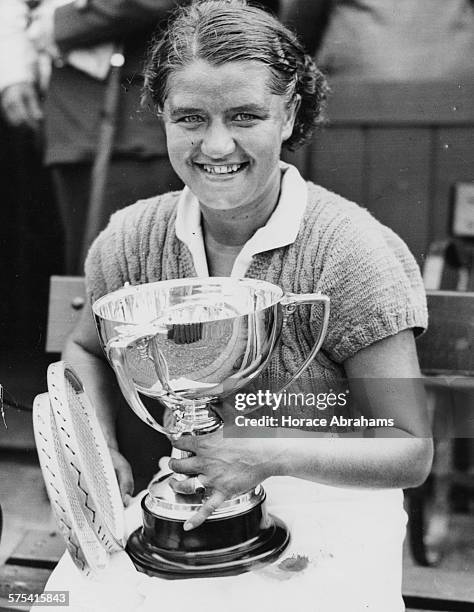 Polish tennis player Jadwiga Jedrzejowska smiling and holding her cup after winning the Beckenham Tennis Final against Alice Marble, England, June...