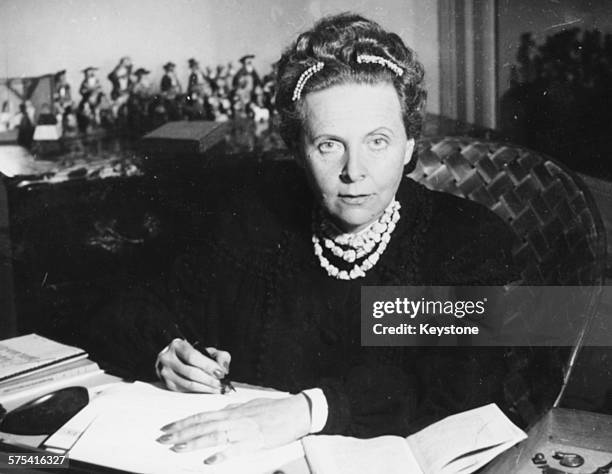 French writer Elsa Triolet, winner of the Prix Goncourt, writing letters at her desk, 1945.
