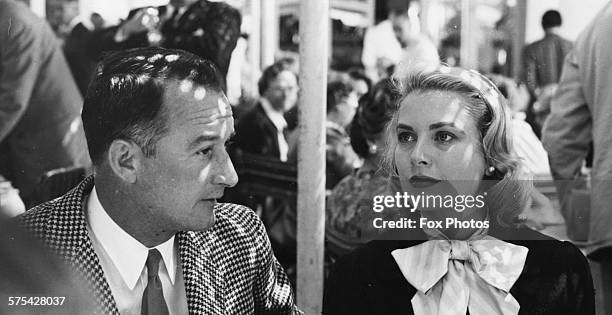 Princess Grace of Monaco pictured with the Mayor of Cannes during a luncheon at the Hotel Martinez, during the Cannes Film Festival, May 1955.