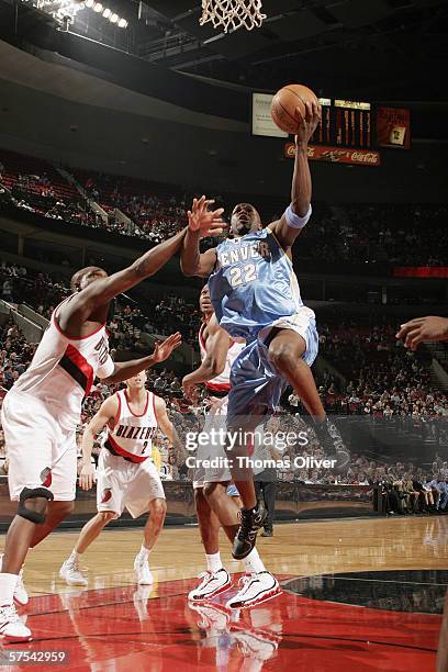 Ruben Patterson of the Denver Nuggets goes to the basket against Zach Randolph of the Portland Trail Blazers at the Rose Garden on April 10, 2006 in...