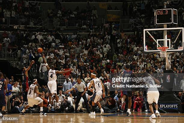 Damon Jones of the Cleveland Cavaliers shoots the game winning shot against Antawn Jamison of the Washington Wizards in game six of the Eastern...