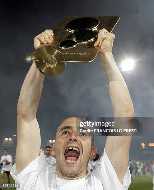 Valencienne's player Orlando Silvestri holds the French L2 championship trophy after their victory 1-0 against Lorient in the French L2 football...