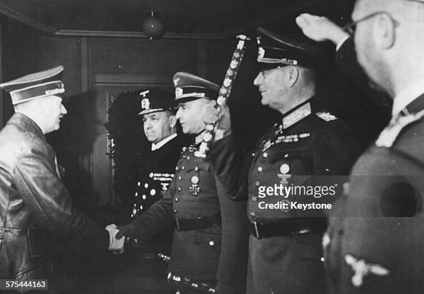 Fuhrer Adolf Hitler shaking hands with a group of German officers; Admiral Erich Raeder, Walther von Brauchitsch, Wilhelm Keitel and Heinrich...