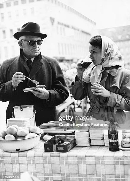 Actor Spencer Tracy eating lunch with local girl Beatrice W, as they film scenes for the movie 'Judgment at Nuremberg' in Munich, May 13th 1961.