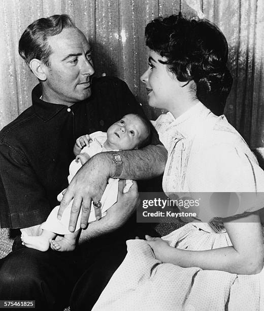 Portrait of actress Elizabeth Taylor and her husband Michael Wilding, with their baby son Christopher, in Los Angeles, CA, June 18th 1955.