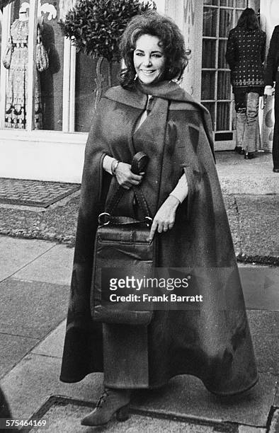 Actress Elizabeth Taylor wearing a long cape as she films scenes for the film 'X, Y and Zee', outside Simone Merman Boutique in Knightsbridge,...