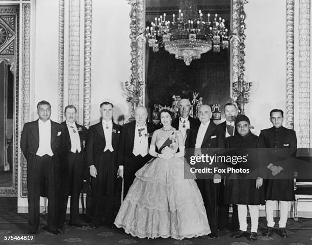 Queen Elizabeth II and Prime Minister Winston Churchill posing for a photograph with the Commonwealth dignitaries attending a dinner at Buckingham...