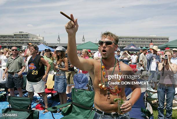 Louisville, UNITED STATES: Jason Magness, of Arkansas, celebrates picking the winning horse in the fifth race 06 May, 2006 at Churchill Downs in...