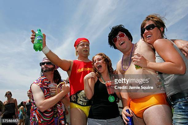 Keith Stenson, Brian Martin and Jeff Allen pose with two female race fans in the infield during the 132nd Kentucky Derby on May 6, 2006 at Churchill...