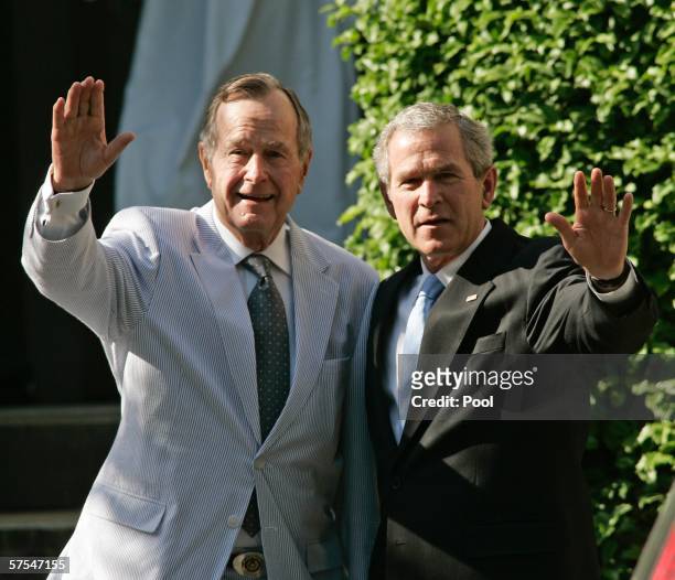 President George W. Bush and his father, former U.S. President George Bush wave as the leave a family wedding at St. John's Episcopal Church May 6,...