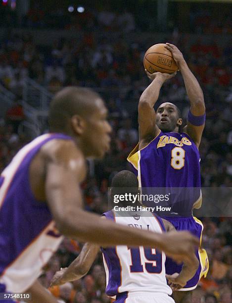 Kobe Bryant of the Los Angeles Lakers shoots a jumper over Raja Bell and James Jones of the Phoenix Suns in the third quarter of game seven of the...