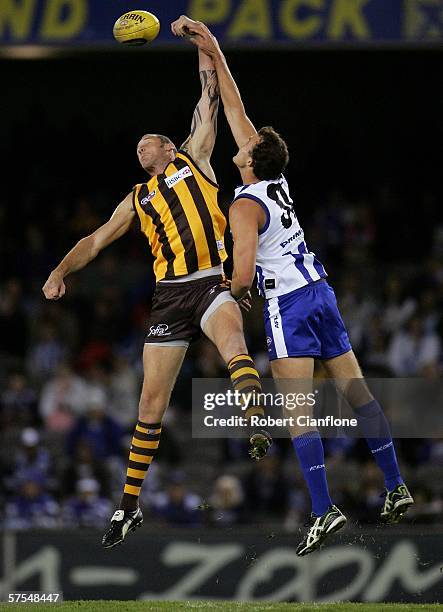 Peter Everitt of the Hawks challenges David Hale of the Kangaroos during the round six AFL match between the Kangaroos and the Hawthorn Hawks at the...