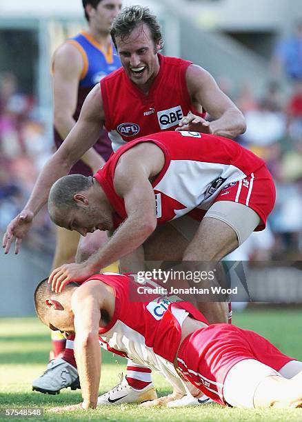 Nick Malceski of the Swans is congratulated by team mates after kicking a goal late in the round six AFL match between the Brisbane Lions and Sydney...