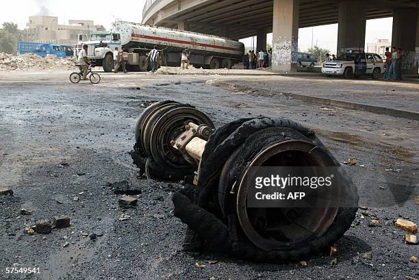 Wreckage lays at the scene of a fire on an oil tanker caused by friction on the wheel axel, in the Ghadir district of Baghdad, 07 May 2006. An Iraqi...