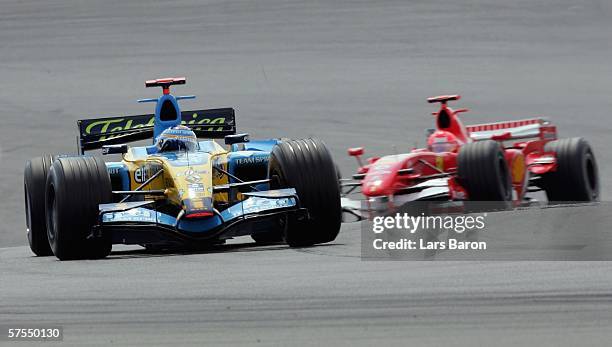 Fernando Alonso of Spain and Renault drives infront of Michael Schumacher of Germany and Ferrari during the F1 Grand prix of Europe at the...
