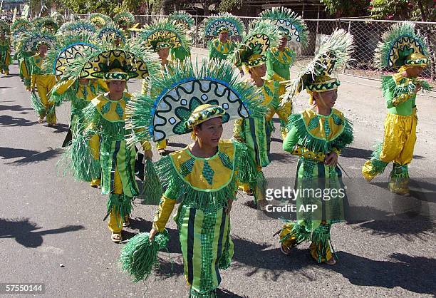 Mandaue, Cebu, PHILIPPINES: Participants display colorful costumes during the annual Mantawi Festival in the central Philippine city of Mandaue in...