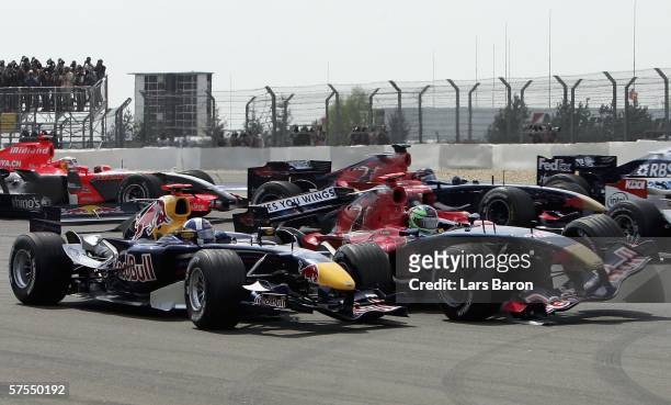 Vitantonio Liuzzi of Italy and Scuderia Toro Rosso crashes into David Coulthard of Great Britain and Red Bull Racing during the F1 Grand prix of...