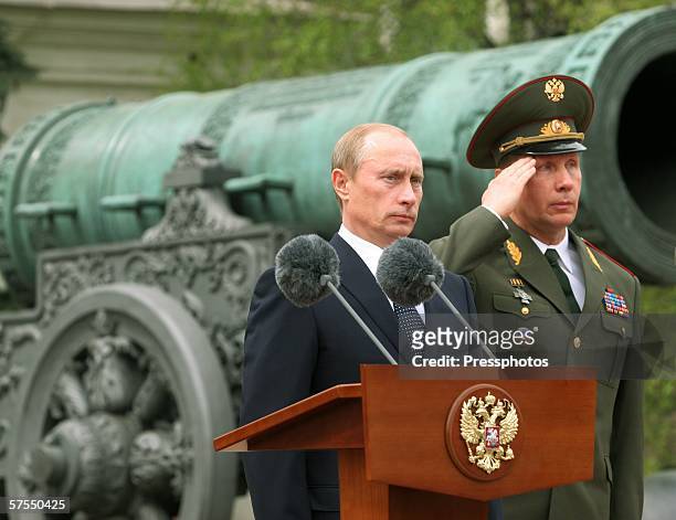 Russian President Vladimir Putin stands near a podium as he participates in the Parade of the Presidential Regiment May 7, 2006 in Moscow, Russia....