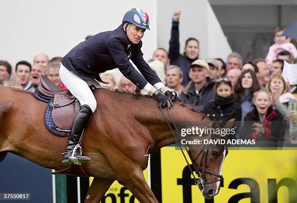 French Michel Robert riding his horse Galet D'Auzay clears a jump during the second stage of the Grand Prix Longines, 07 May 2006 in La Baule. He...