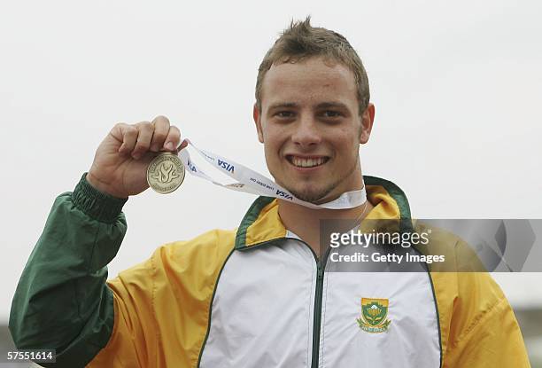 Oscar Pistorius of South Africa celebrates winning his second gold medal during the VISA Paralympic World Cup Athletics at the Sport City Stadium on...