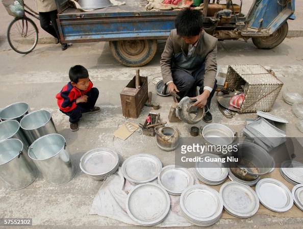 Chinese Farmer labors At A Market On The Outskirt Of Baoding City