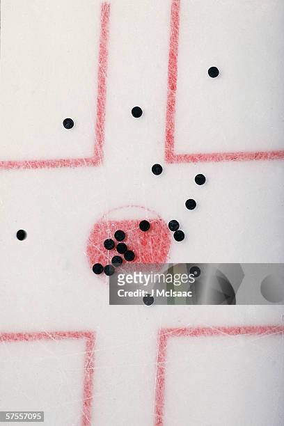 Overhead view of pucks on the ice of a hockey rink, April 2000.