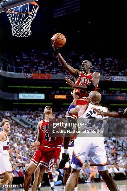 Michael Jordan of the Chicago Bulls shoots a layup against Charles Barkley of the Phoenix Suns during a game of the NBA Finals on June 9, 1993 at the...