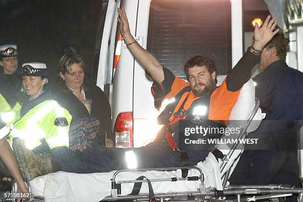 Australian miner Todd Russell is stretchered into Launceston Hospital as wife Caroline watches after being trapped deep underground for two weeks and...