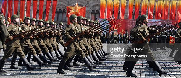 Russian military personnel, wearing Red Army uniforms, hold WWII era rifles as they march, in unison, in a military parade at Red Square May 9, 2006...