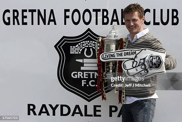 James Grady of Gretna FC is seen with the Scottish Cup trophy at Raydale Park on May 9 Gretna, Scotland. Gretna will face Hearts at Hampden Park in...