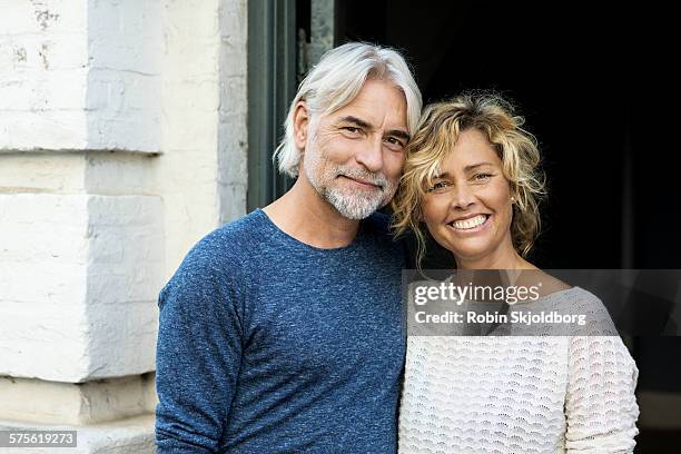 portrait of man and woman smiling - blue blouse stock pictures, royalty-free photos & images