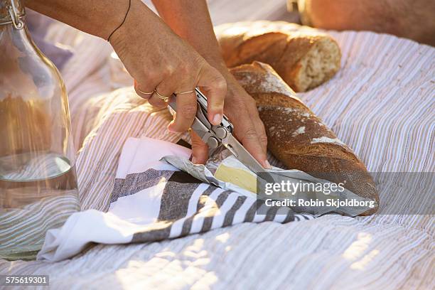 closeup of womans hand cutting cheese - swiss knife stock pictures, royalty-free photos & images