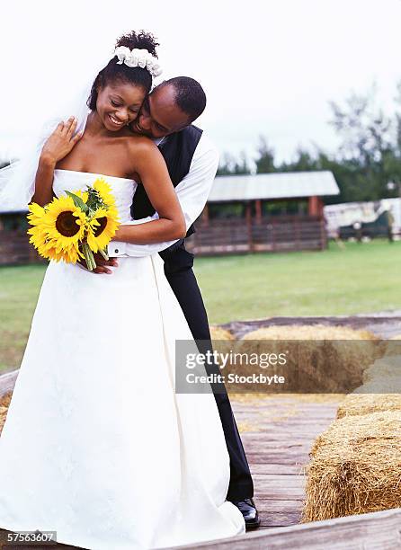 portrait of a groom holding the bride from behind - front on groom and bride stock pictures, royalty-free photos & images