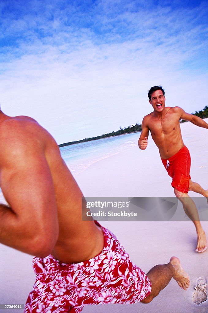 View of two men running at the beach