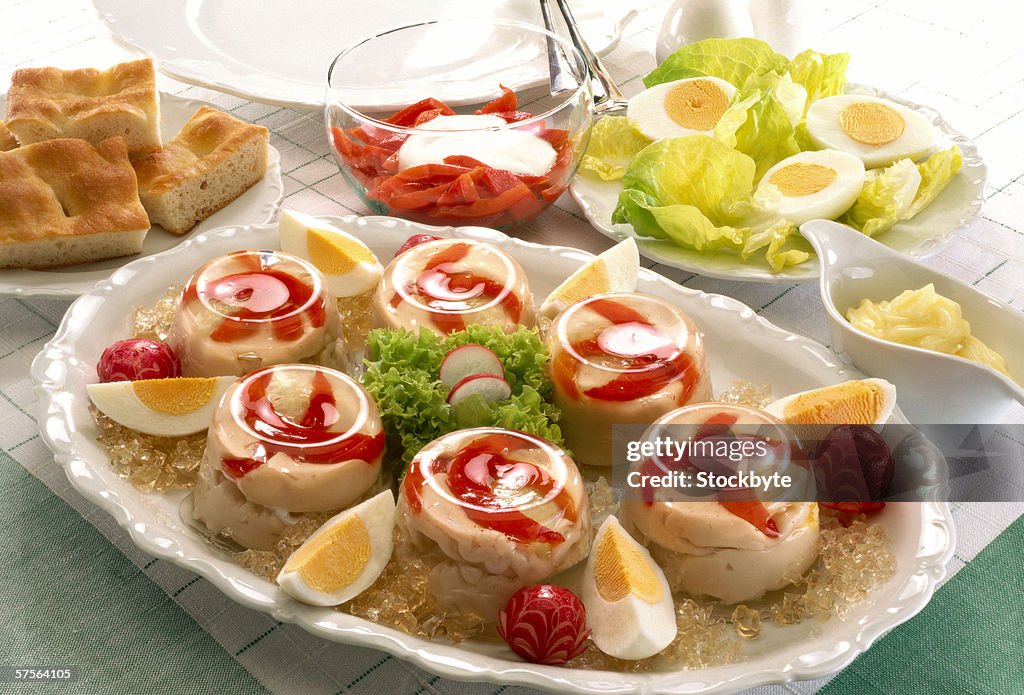Close-up of a pate appetizer served with boiled egg garnish and bread