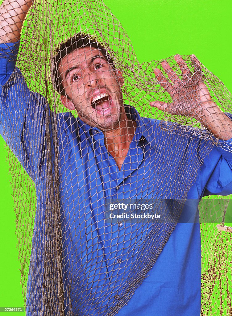 Close-up of a man caught in a fishing net