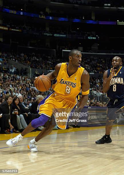 Kobe Bryant of the Los Angeles Lakers moves the ball against Anthony Johnson of the Indiana Pacers during the game at Staples Center on January 9,...