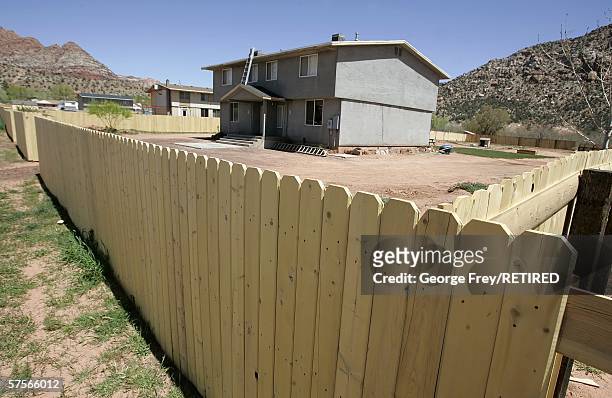 Recently built fence surrounds a house in Hildale, Utah April 20, 2006. The house sits on United Effort Plan Trust land which was once controlled by...