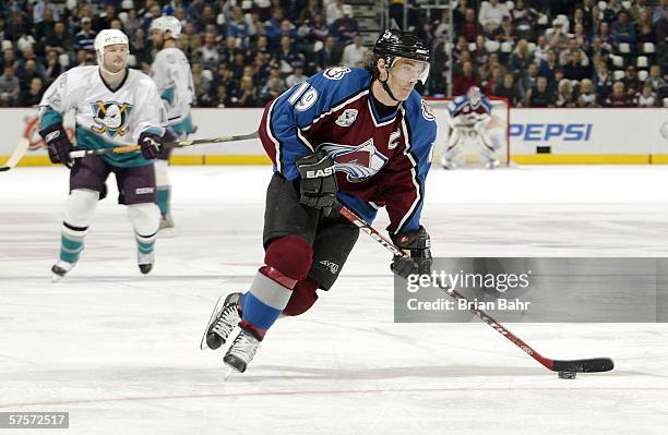 Joe Sakic of the Colorado Avalanche gets out ahead of the Mighty Ducks of Anaheim for a shot on goal in the first period during game three of the...