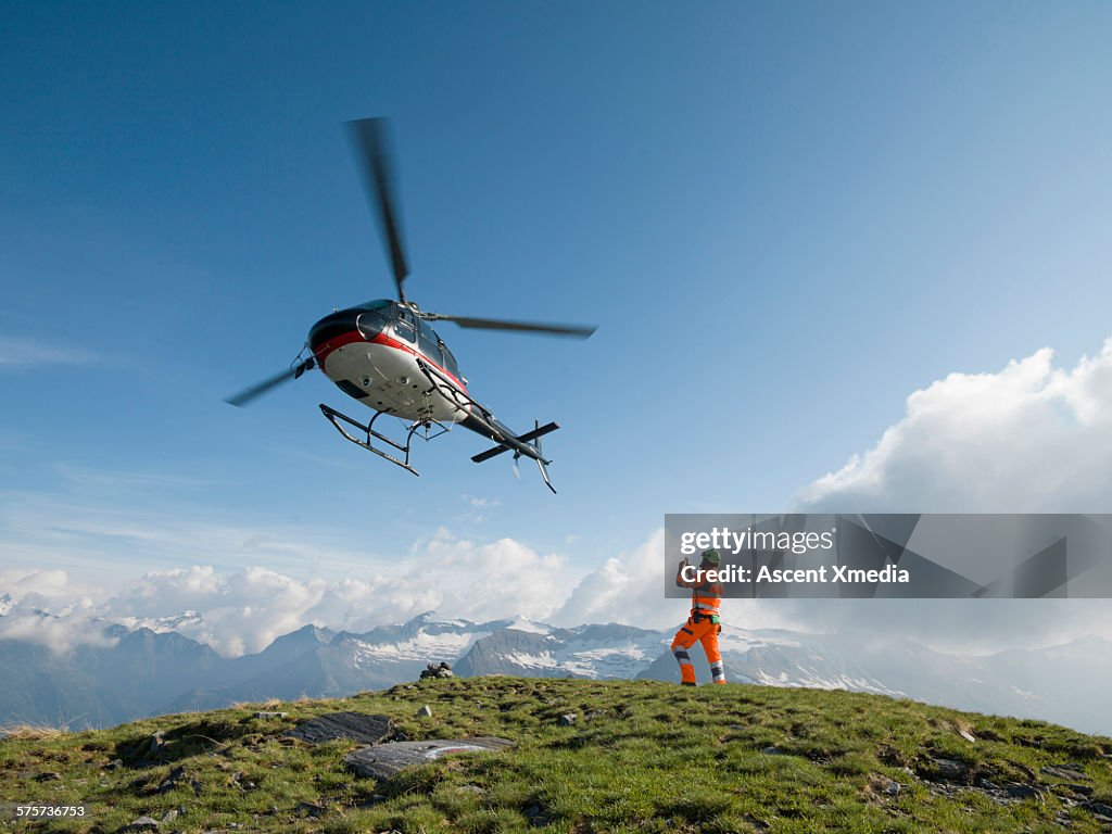 Ground crew member takes pic of departing copter