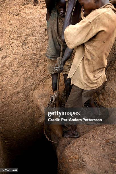 Unidentified young men work in a cobalt mine on December 14, 2005 in Ruashi mine about 20 kilometers outside Lubumbashi, Congo, DRC. Children as...