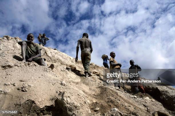 Unidentified young boys works among about 4,000 artisan miners digging copper on December 13, 2005 in Ruashi mine about 20 kilometers outside...